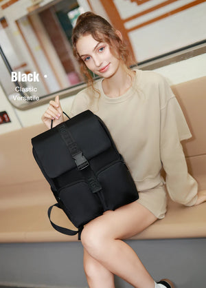 Black compact commuter backpack with front flap, buckle straps, and top handle