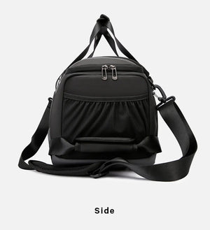 Black waterproof duffle bag with front zip pocket and adjustable shoulder strap