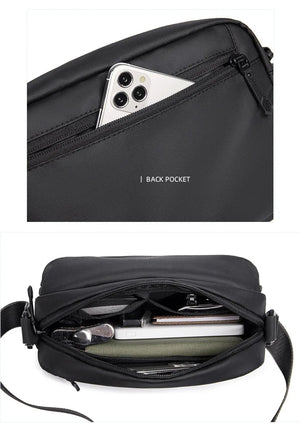 Black crossbody bag with back pocket holding a smartphone and zip main compartment