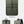 Green backpack view: front flap, side panel pocket, and adjustable shoulder straps