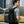 Black waterproof travel backpack with multiple front pockets and padded shoulder straps