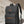 Black commuter backpack with top handle, flap closure, and side buckle strap details
