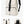 Beige compact commuter backpack with top flap, front pocket, and adjustable shoulder straps