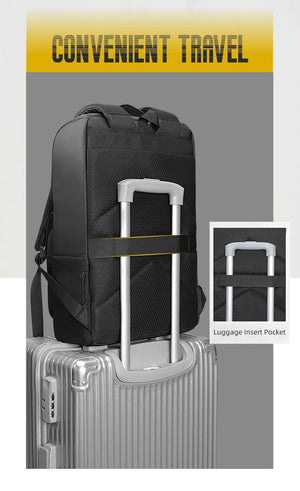 Black commuter backpack with luggage strap pocket and trolley handle insert
