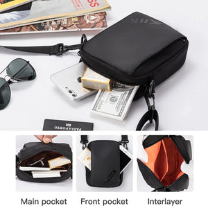 Black crossbody bag showing main pocket, front pocket, and an inner divider