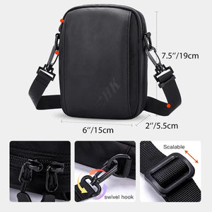 Black compact crossbody bag with side clips and front zipper closure