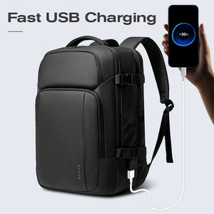 Black waterproof travel backpack with USB charging cable port and front buckle straps.