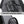 Grey crossbody bag detail view of two-way smooth zipper and carry handle