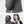 Grey waterproof crossbody sling bag worn over the shoulder with front pocket.