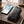 Black leather slim card holder wallet with stitched design and metal logo.