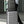 Waterproof travel backpack secured over a rolling suitcase with a top trolley strap