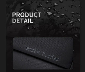 Black textured bag fabric with arctic hunter logo on the front panel