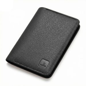 Black leather passport wallet, textured front with embossed logo, angled view