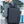Black compact backpack on a man walking outdoors