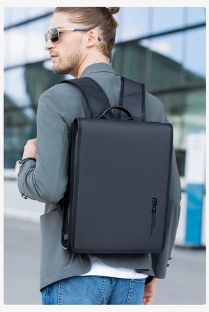 Black compact backpack on a man walking outdoors