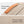 Beige laptop bag with orange-trim handle strap and water-repellent textured fabric