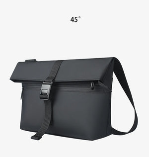 Black compact messenger bag angled view with flap top and adjustable shoulder strap