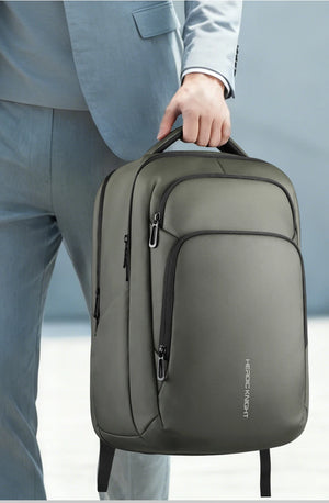 Green backpack with top handle and front vertical zipper pocket