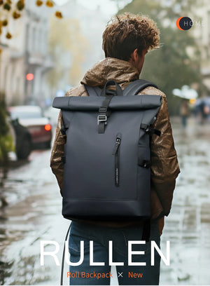 Dark roll-top waterproof travel backpack worn on back with buckle front strap