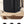 Black travel backpack on a table with USB charging port and multiple accessory icons