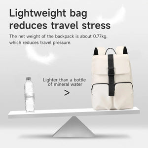 Light beige commuter backpack with front flap, dual straps, and compact upright shape