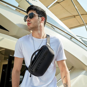 Black arctic hunter crossbody bag worn crossbody with adjustable strap and zipper pocket