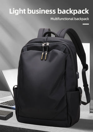 Black business commuter backpack with curved shoulder straps and front zip pocket