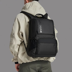 Black travel backpack with front zip pockets and padded back panel