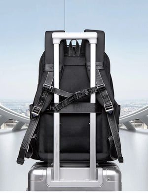 Black waterproof backpack with back luggage strap for securing to a suitcase handle