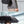 Black backpack worn by person in rain, shown with different angles