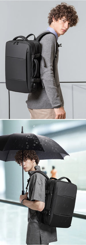 Large black backpack on model with side strap adjustment and top carry handle