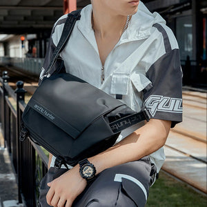 Black crossbody messenger bag with front flap pocket and webbing shoulder strap