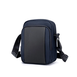 Blue compact messenger bag with front zip panel and adjustable shoulder strap