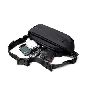 Black crossbody bag opened showing organizer compartments and internal zip closure