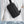 Black crossbody bag with front zip pocket and textured side panel details