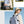 Light blue waterproof travel backpack worn outdoors, front and side views for strap details