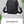 Black compact crossbody bag with rounded corners and adjustable shoulder strap