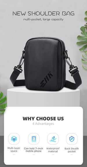 Black compact crossbody bag with rounded corners and adjustable shoulder strap