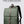Green waterproof commuter backpack with front flap, shoulder strap, and brown pull tab