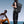 Black travel backpack worn on back with front flap and padded shoulder straps