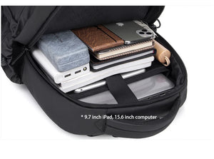Open black backpack interior with devices and documents in padded compartments