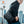 Black compact crossbody bag with front flap and adjustable shoulder strap
