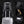 Black backpack with retractable trolley handle, shoulder strap card pocket, and sunglasses hook