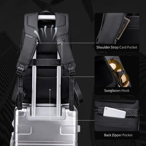 Black backpack with retractable trolley handle, shoulder strap card pocket, and sunglasses hook