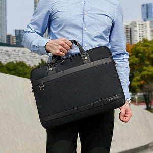 Black waterproof laptop bag with top handle and crossbody shoulder strap