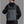 Black waterproof travel backpack worn on back with top handle and side straps