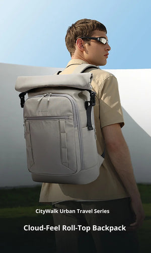 Light gray roll-top backpack with front zip pockets and vertical utility straps