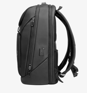Black waterproof travel backpack side view with padded panels and carrying handle