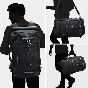 Black waterproof hiking backpack worn with adjustable shoulder straps and side handle