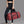 Red waterproof duffle sports bag with wide handles, side pockets, and zip front